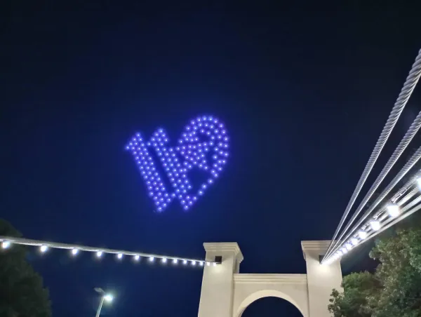 Drone show displaying Waco city logo over historic Waco suspension bridge