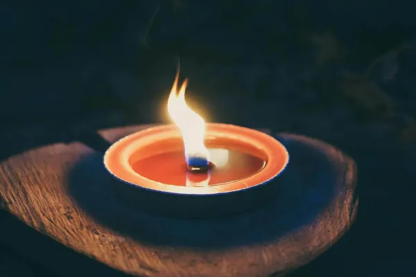 candle on wooden platform