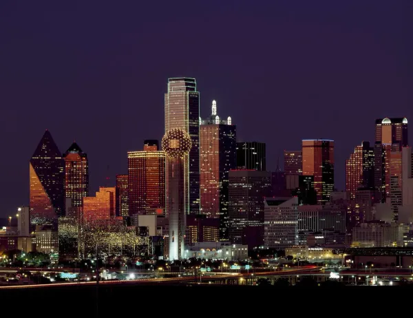 brown building downtown Dallas Texas with lights on during night time