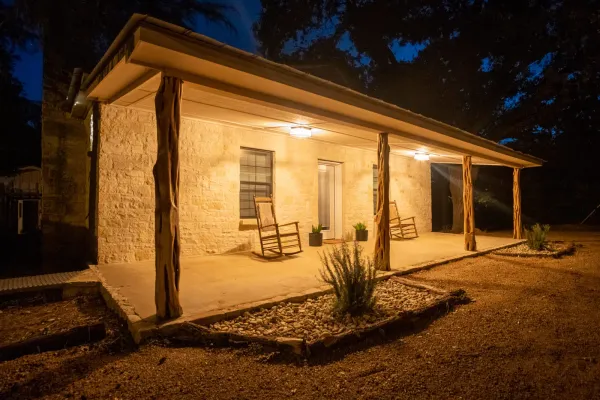 A vacation rental house in Fredericksburg called Olive Street Ranch lit up at night