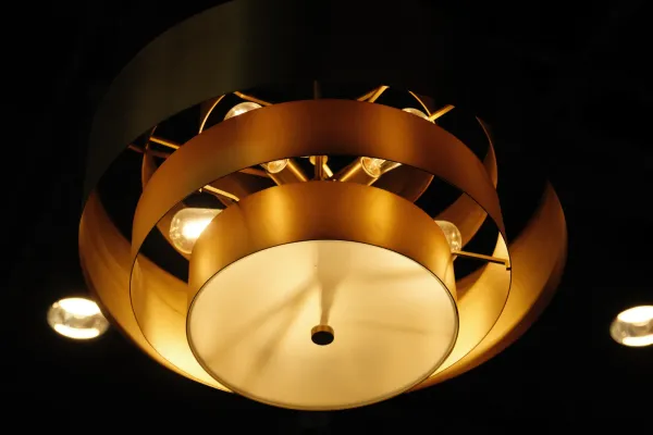 A gold-colored light fixture hanging from the ceiling at Reign Coffee Co in Waco, TX