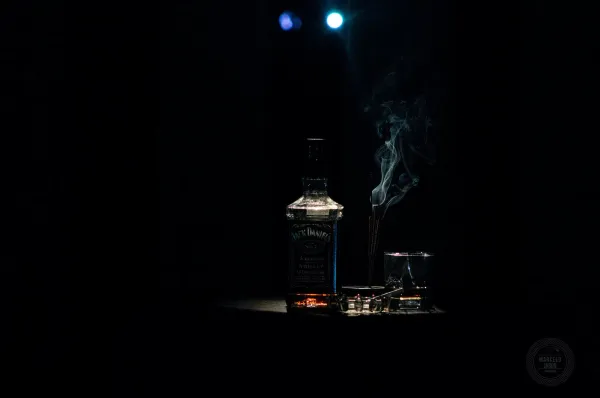 closeup photo of liquor bottle against black background